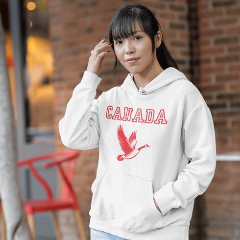 This hoodie celebrates the Canadian goose, wings spread wide, flying across Canada (and probably plotting its next lawn invasion).